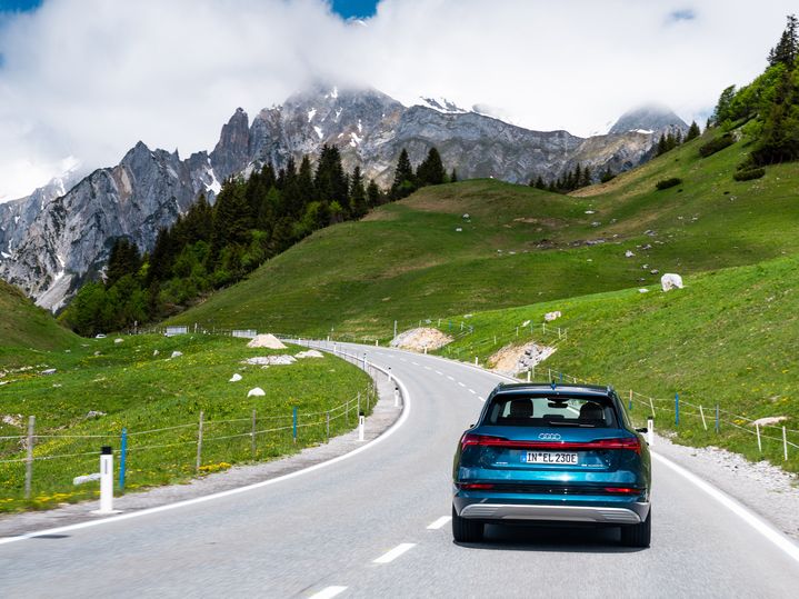 A rear view of the Audi e-tron electric car in the mountains.