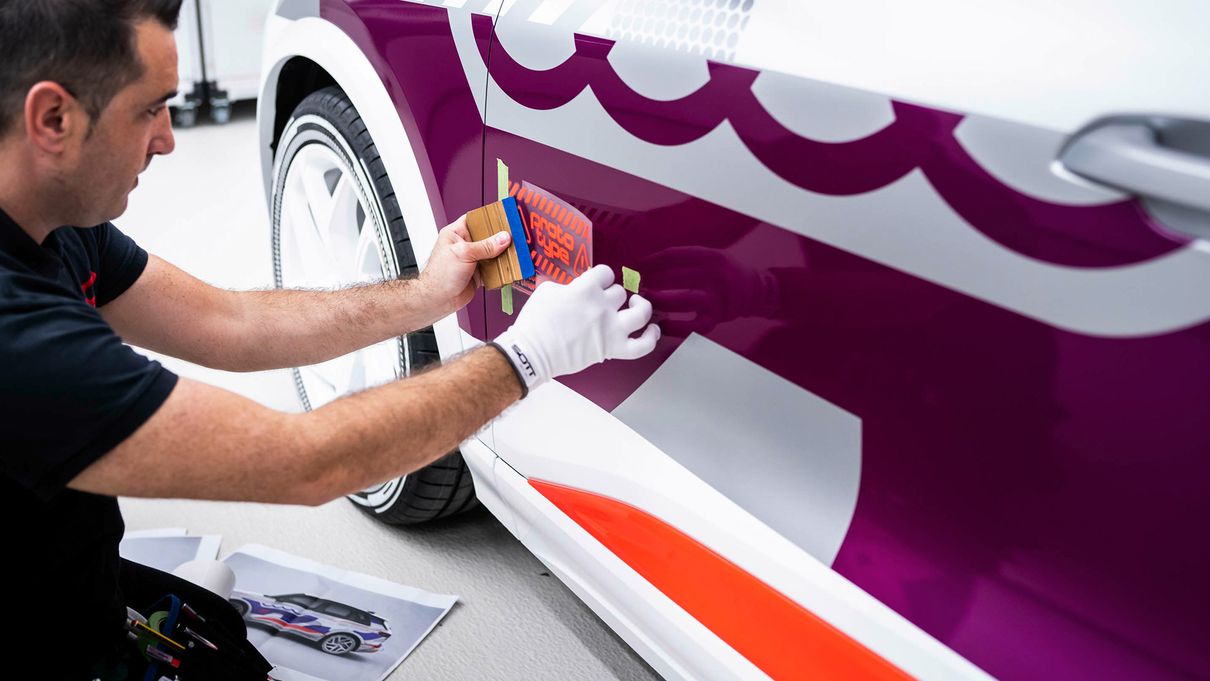 Employee applying adhesive film to the vehicle door