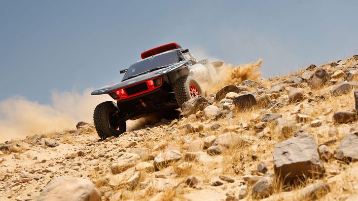 Audi RS Q e-tron dashing over rocky hill