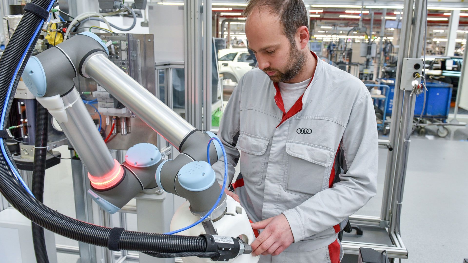 Human-robot cooperation in the assembly of Audi-A4/A5 models: “Adhesive application with robot assistance,” abbreviated from the German as KLARA, provides support to the employees with the installation of large CFRP roofs in the new Audi RS 5 Coupe (fuel consumption combined in l/100 km: 8.7; CO2 emissions combined in g/km: 197).