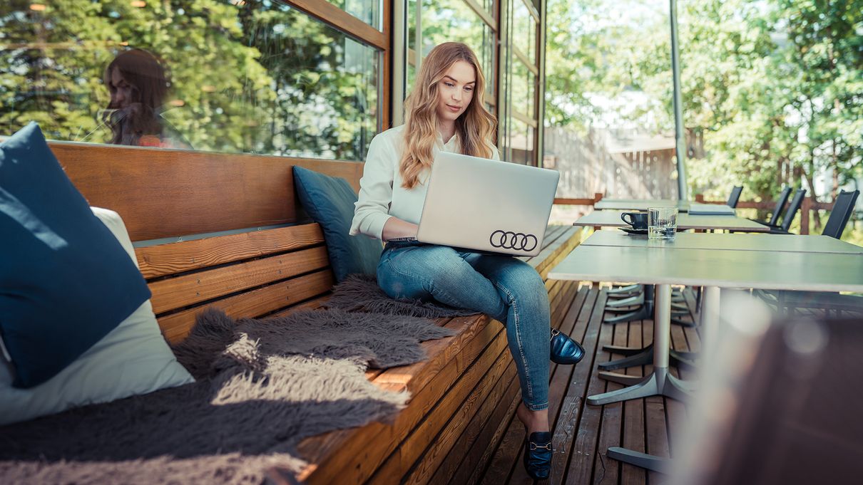 Young woman on laptop works concentrated in home office 