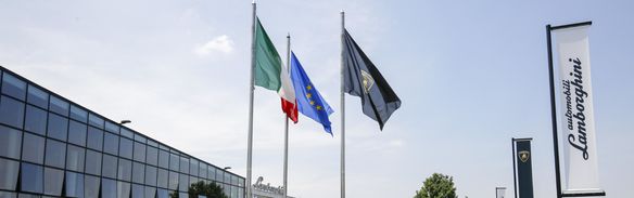 Flags in front of a Lamborghini building
