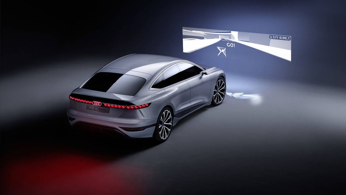 The Audi A6 e-tron concept casting projections into the air
