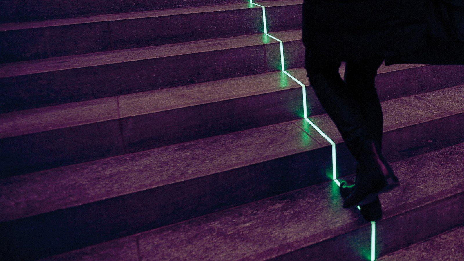 A staircase with a green light strip