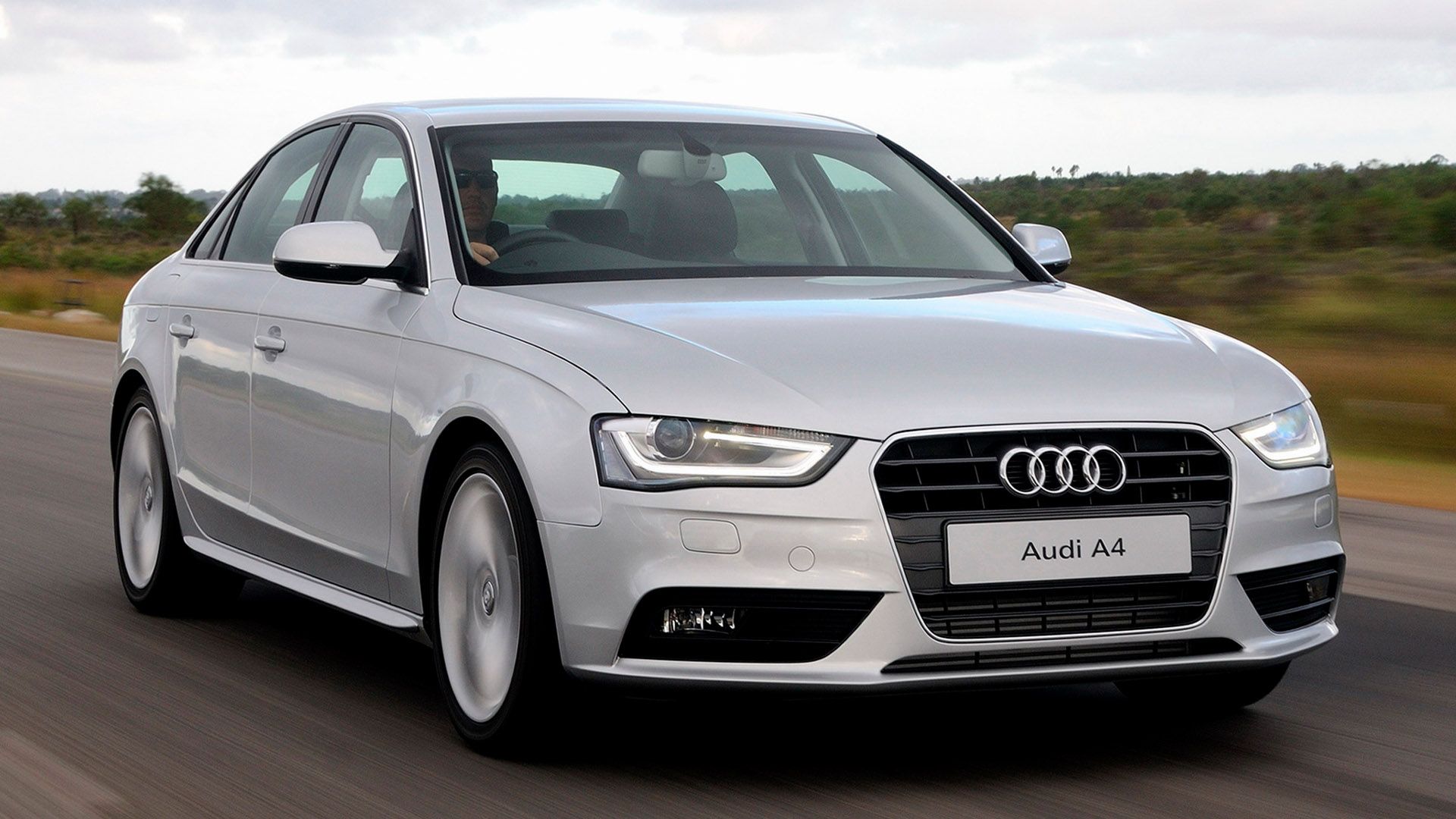 Silver Audi A4 saloon driving on a road