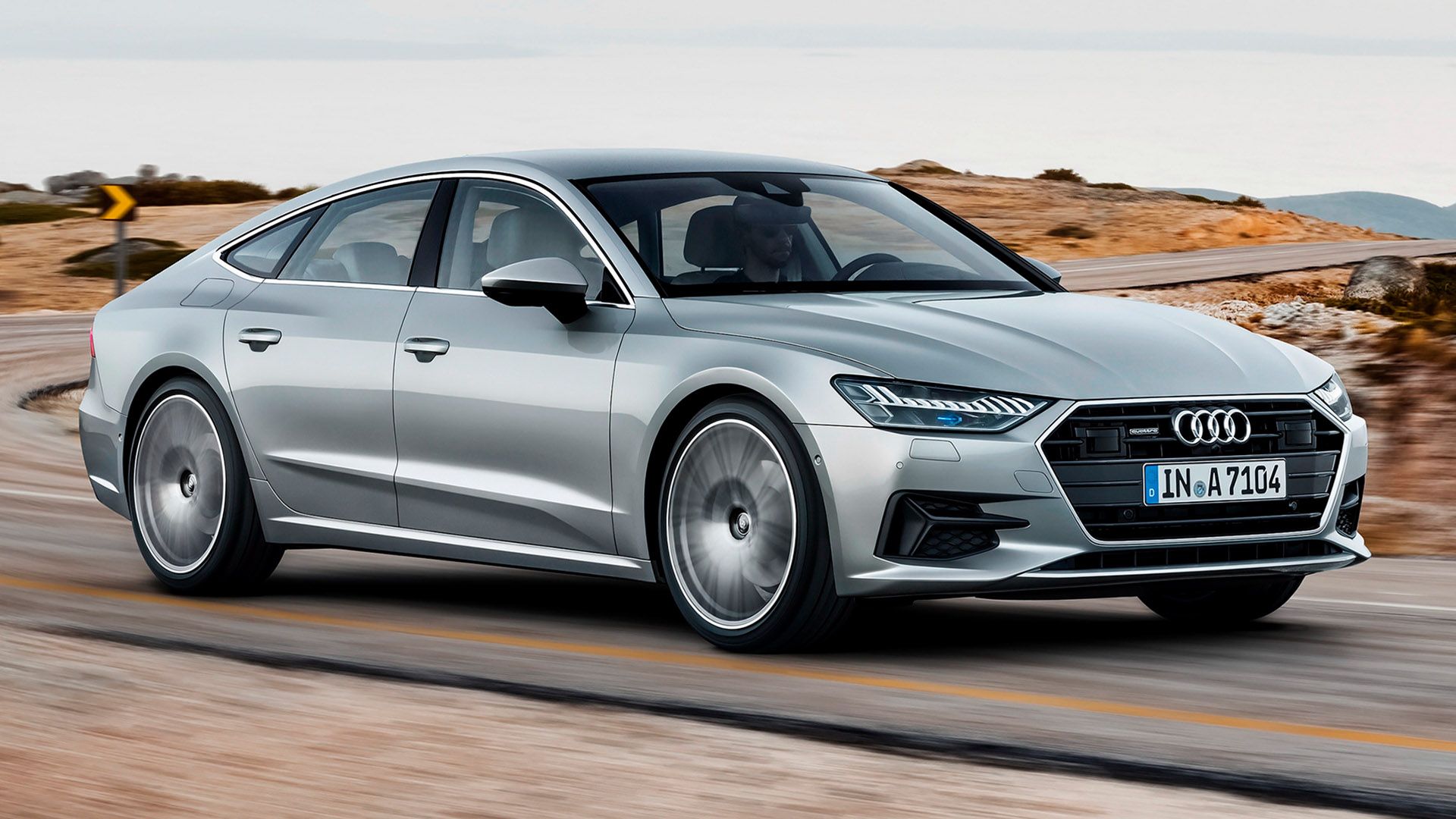 Silver Audi A7 Sportback drives on a road