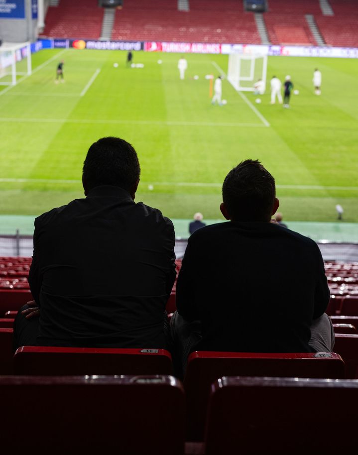 Zwei Männer schauen im Stadion ein Fußballspiel