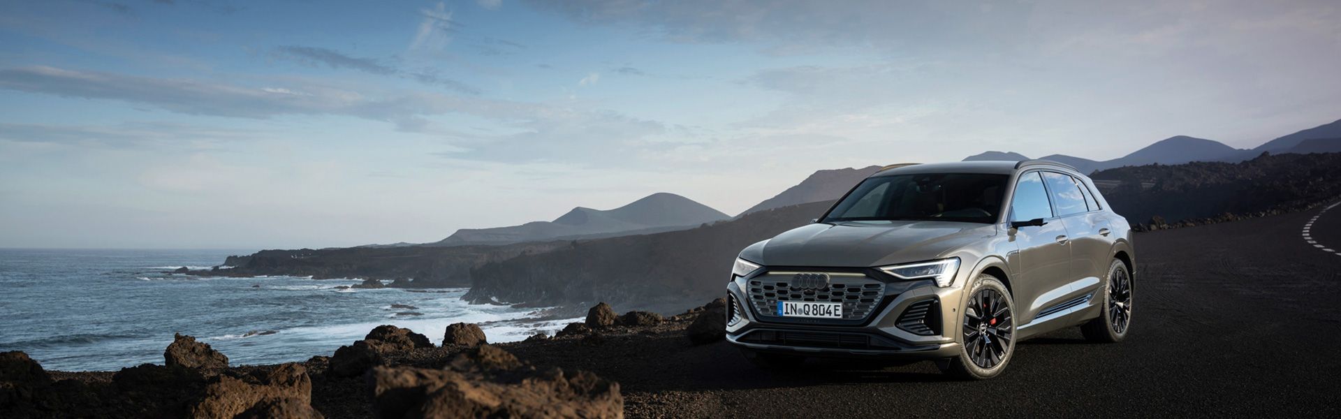 Audi Q8 e-tron stands on picturesque rock cliff