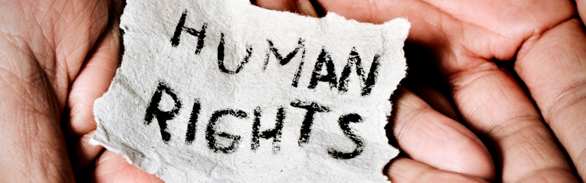 Hands holding a piece of paper with the inscription Human Rights